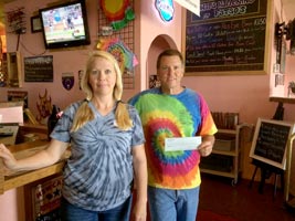 Fatso's Pizza owners with donation check